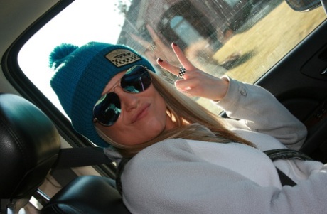 A hot blonde named Madden with sunglasses on in the snow teasing her seductively.