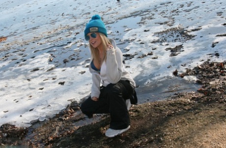 Seductively teasing in the snow with Madden, who is hot blonde and wearing sunglasses.