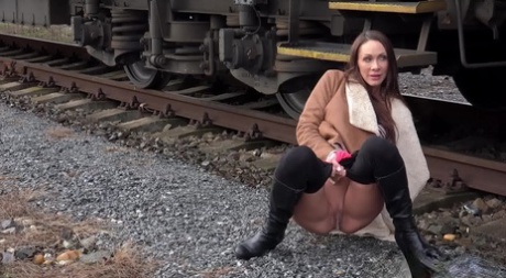 Cynthia Vellons Pulls Down Black Tights For A Quick Piss Near Railway Cars