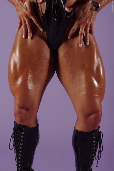 In her sequins, Lisa Cross loosening up in boots while wearing a provocative swimsuit as a blonde bodybuilder.