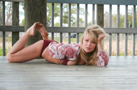 The naked girl named Meet Madden dresses in a bathing suit and panties, performing suggestive poses on the deck.