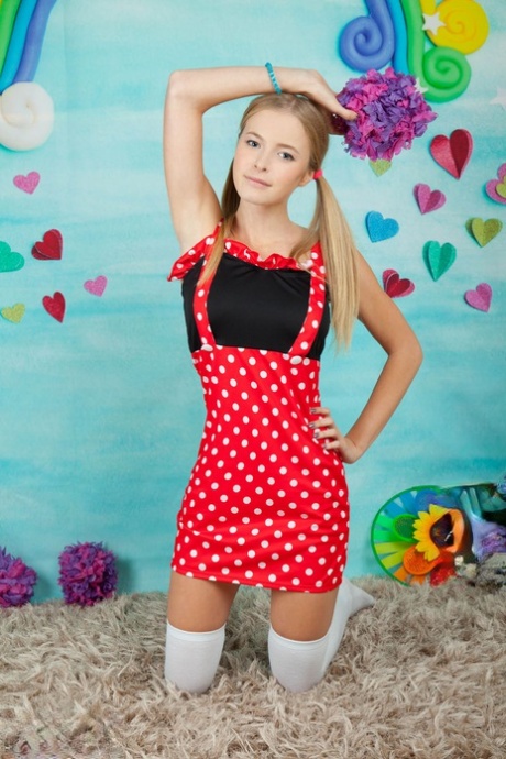 Charming Young Girl Shows Her Tan Lined Body In Long Socks And Pigtails