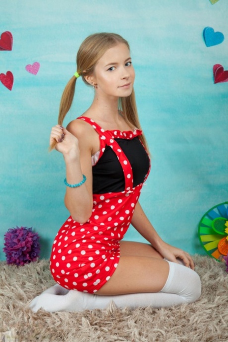 Charming Young Girl Shows Her Tan Lined Body In Long Socks And Pigtails