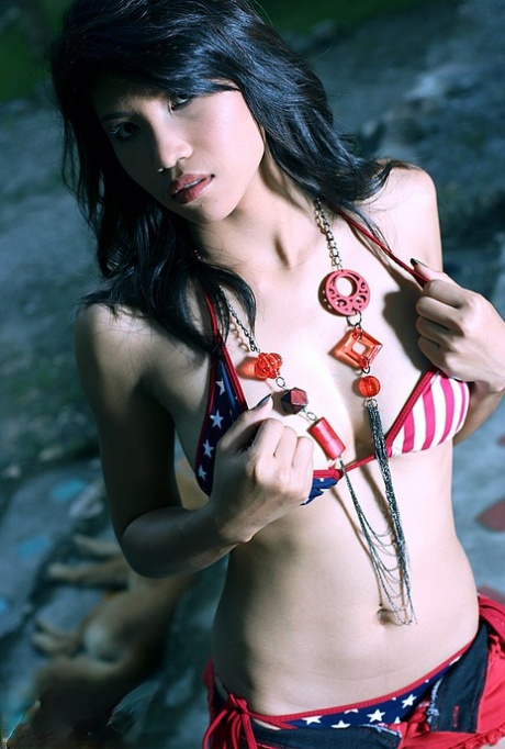 The attractive look on Anny Wadee, a Thai girl with dark hair, removes her bikini in a tempting manner.