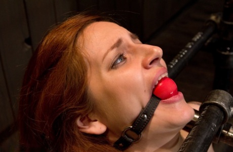 In bondage, the natural redhead experiences painful nipple play.