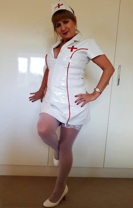 After disrobing her breasts during a BJU show, Lorna Blu, the older nurse, performs oral pleasure during an awkward BJU event.