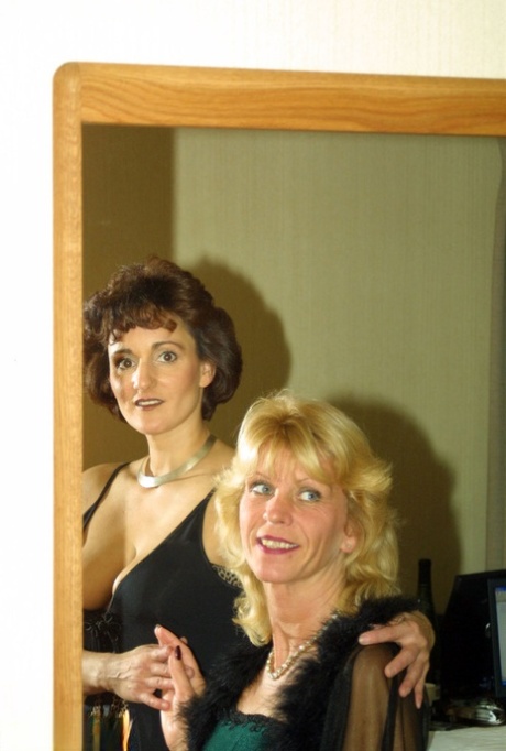 Mature dykes engage in sexual activity while locked in a motel room, kissing each other in their nylons.