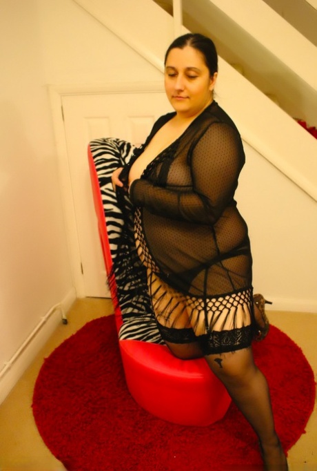 Amateur plumpster Kimberly Scott models her oversized chest with hosiery and high heels.