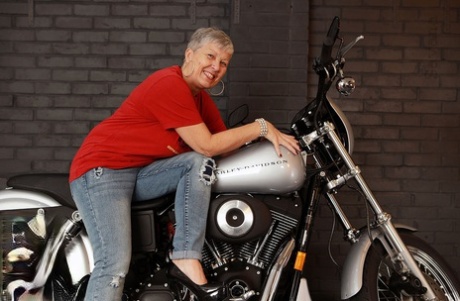 Older Savana models in lingerie on a Harley Davidson motorcycle.