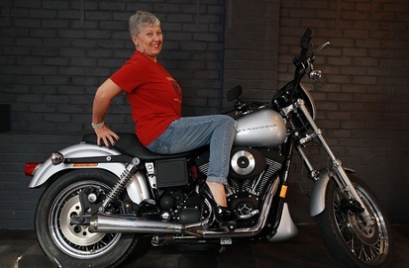 Sexy old Savana models on top of a Harley Davidson motorcycle.