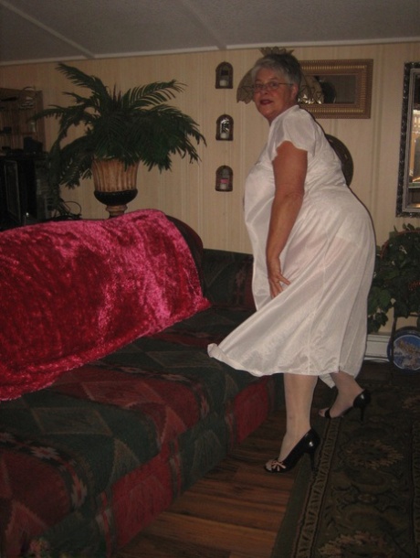 Obese grandmother removes her lace lingerie to pose in OTK nylons while wearing them.