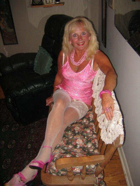Ruth, who is older than her peers and blonde, exposes her satin lingerie while wearing white stockings for POV sex.