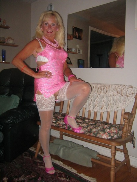 Before POV sex, Ruth who is blonde and has a blonde chest appears in satin lingerie while wearing white stocking.