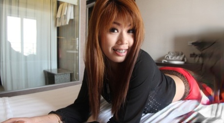 A beautiful Asian redhead named Ming is hit on the bed by an exchange student.