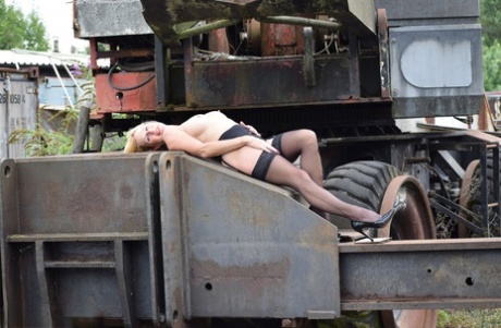 The busty blonde model makes her debut modeling off the runway, atop heavy equipment.