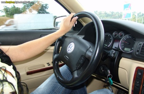 Despite being a brunette amateur, Busty Reny flaunts her large tits while driving.