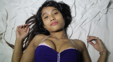 A close-up of Filipina Teen Porn shows her nude muffuff with hair removed from her face after getting on a bed.