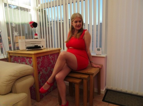 No panties, just a blonde amateur climbing up her red dress with red heels.