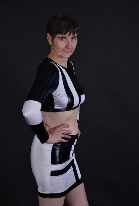 The granny's dark haired face displays her sagging tits and pussy for the first time.
