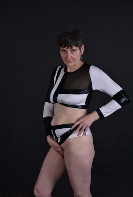 Her sagging pussy and tits are revealed to the world for the first time by granny, who has dark hair and freckles.