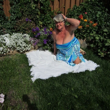 At flower bed, the Fat nan Girdle Goddess exposes herself to sheer pantyhose on a blanket.