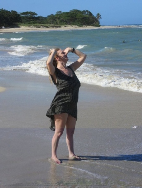 While walking on a beach, Lily May, an older UK amateur, looses her large breasts.