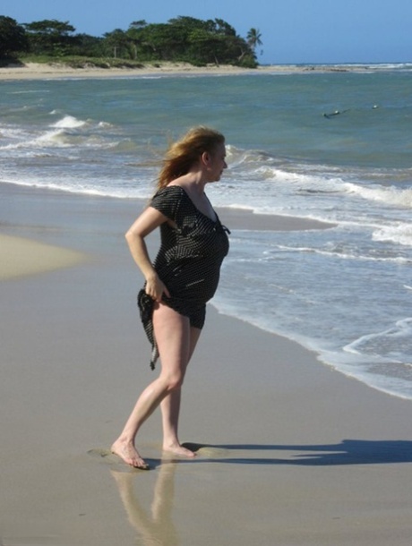 The beach attracted Lily May, an older British athlete, as she walks with her massive chest muscles.