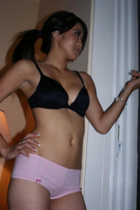 Asian first timer Taya pauses for a smoke break in her bra and panties