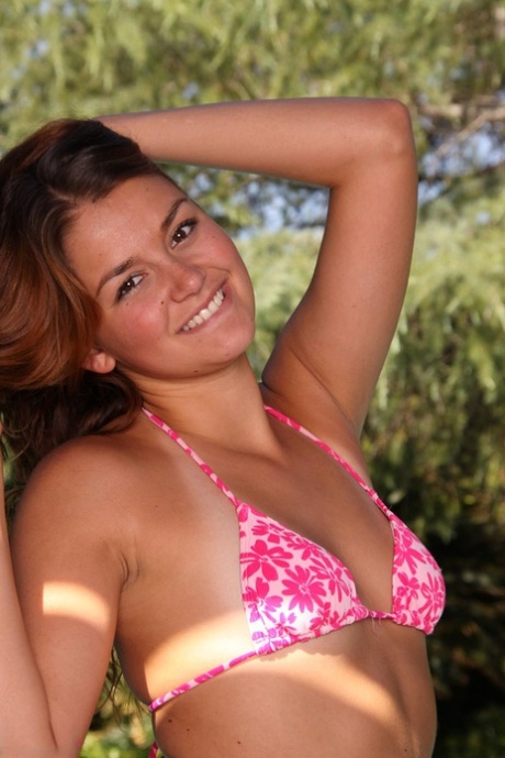 A cute teen named Allie Haze makes her first nude pose by taking off her bikini at the pool.