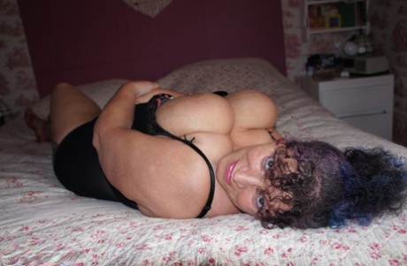 Big titted horny mature in black lingerie showcasing her massive big BBW tits