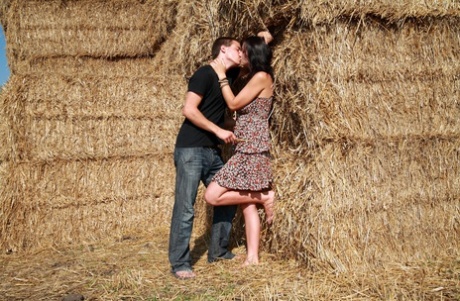 The young couple have intercourse while being surrounded by straw bales.