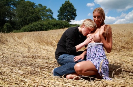 Spoiled in a field of grown wheat, young couple have sexual intercourse together.