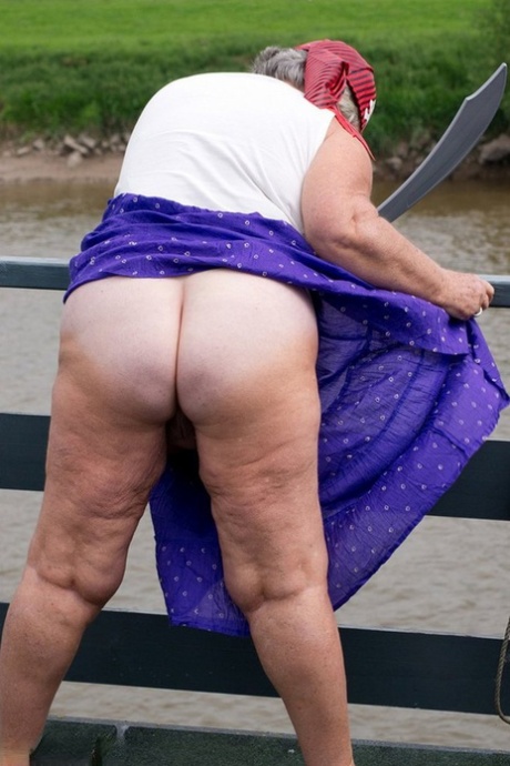 Pirates: Fat British granny bares her legs on a bridge while wearing pirate uniforms.