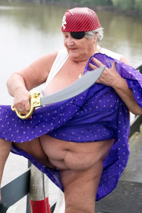 Despite her pirate outfit, fat British granny flaunts herself on a bridge.