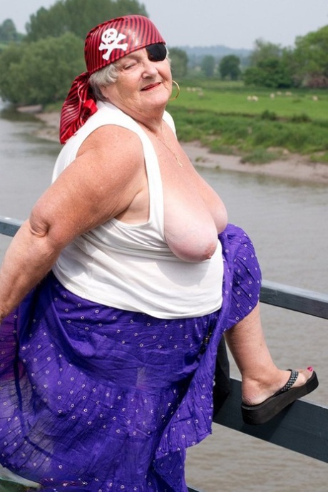 In her pirate attire, a fat British granny emerges on a bridge while flaunting her body.