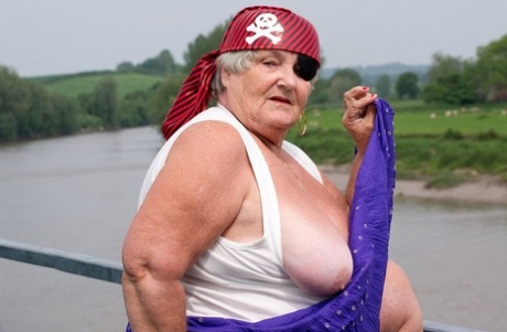 The overweight British granny flaunts her body on a bridge while dressed in pirate costume.