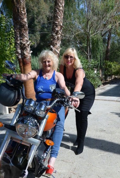 Older blonde Melody finds a woman's breasts and fondles on her motorcycle.