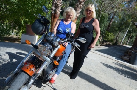 The old blonde, Melody, finds a woman's breasts and fondles on a motorcycle.