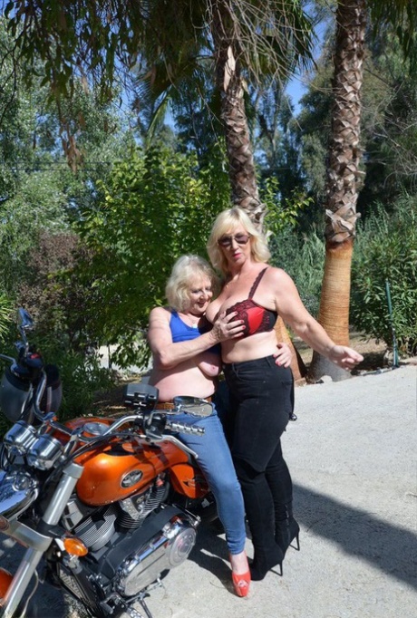 While riding on a motorcycle, Melody breaks out her arms around an old blonde and displays fondles on top of one of the women's breasts.