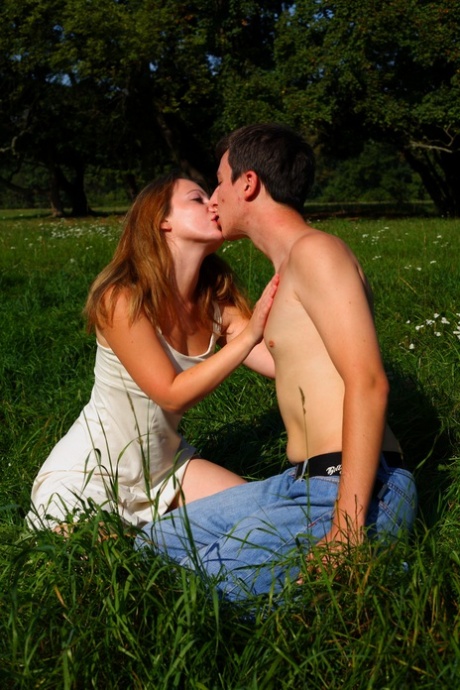 Prone to the sex: Young couple have sex in a field, away from sight.