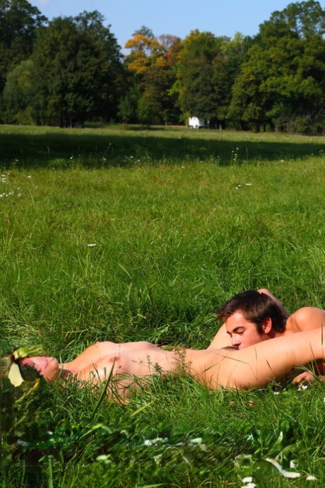 Girl and her boyfriend take off their clothes to have sex in the grassy area.