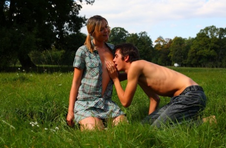 Blonde teen and her boyfriend have sex in the middle of a field