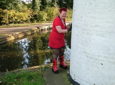 Young redhead Valgasmic Exposed bares herself on the footbridge wearing punk boots.