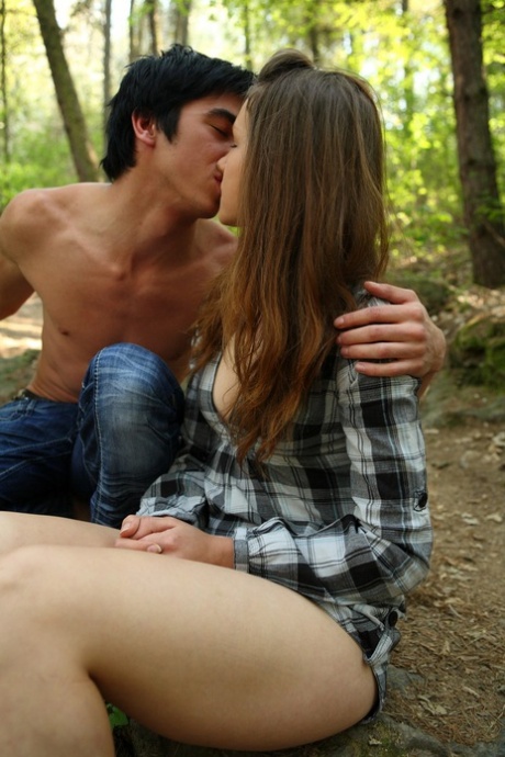 On a forest path, a young girl and her boyfriend engage in sexual activity.