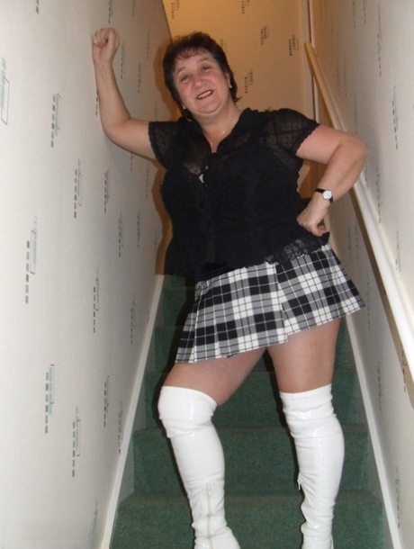 Mature BBW Kinky Carol gets naked in her underthings and OTK boots on stairs