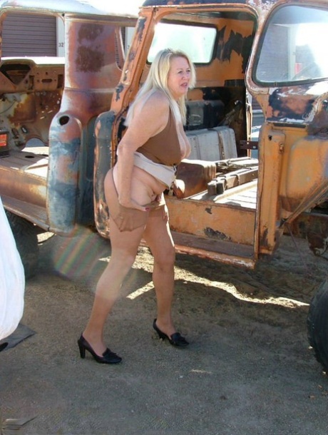 Aged, blonde women exhibit their ample stomachs and buttocks on unadorned heavy equipment.