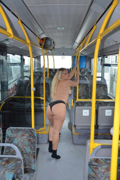 Thick blond chick takes off her underwear to pose naked in socks on a city bus