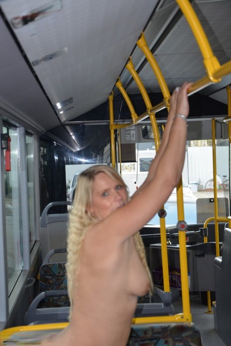 Thick blond chick takes off her underwear to pose naked in socks on a city bus