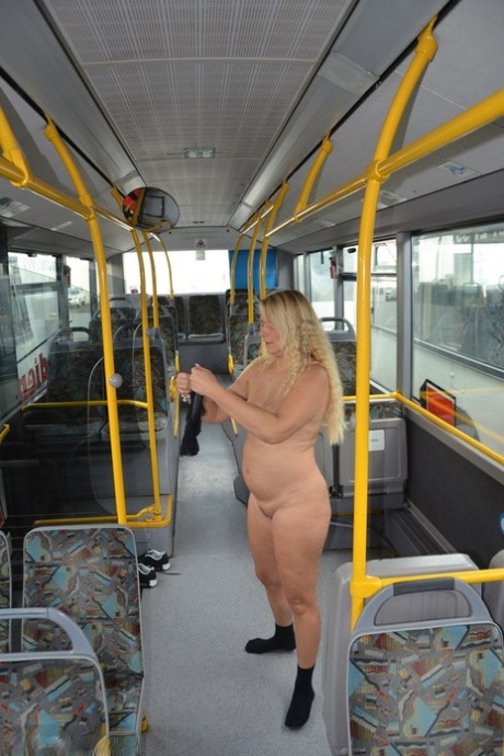 Thick blond chick takes off her underwear to pose naked in socks on a city bus