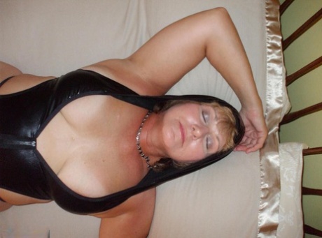 BustyBliss, a senior woman, displays her natural tits in and out of lingerie.